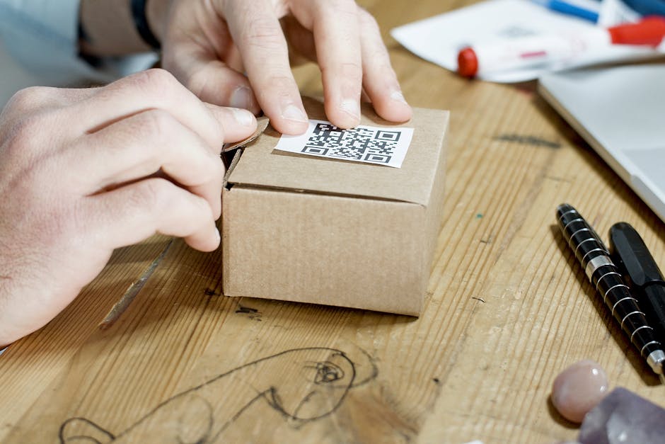 Close-up of hands packing a box with a QR code, symbolizing online business services.